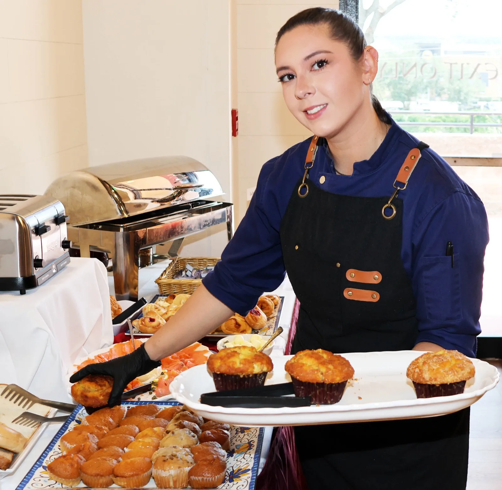 Kitchen staff plating muffins at the Sunday brunch pastry station at The Venue Clermont